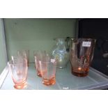 A peach tinted glass lemonade set, and additional glass jug