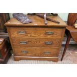 An oak three drawer chest with Art Nouveau metal handles