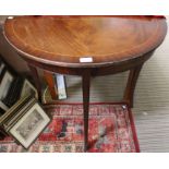 A reproduction mahogany finished demi-lune table