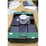 A box containing boxed Royal Worcester commemorative mugs