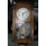 A 1920s oak cased wall clock