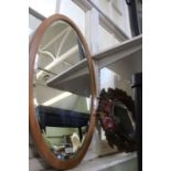 Two oval bevelled wall mirrors