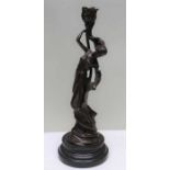 A reproduction bronze effect Art Nouveau Candlestick of female form, impressed Milo on polished