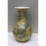 A yellow Lladro vase decorated with a dragon, 25.5cm