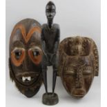 Two African Tribal masks, both carved one with painted decoration and fibre beard, 32cm long, togeth
