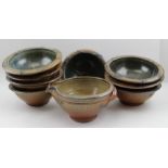 A Toff set of eight glazed stoneware studio bowls, with tube lined decoration, signed