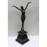 A reproduction bronze effect figure of an Egyptian slave girl, on a polished plinth base, 55cm high