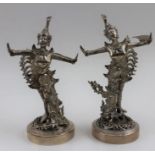 A pair of 20th century South East Asian silver figures, dancers in traditional costume, raised on pi