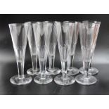 A set of eight 19th century Champagne flutes, facet cut with ground pontils