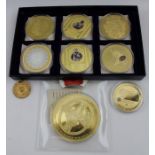 A collection of gilded medal coins, includes "Canonizatio Joanes Paulus II", inset Swarovski crystal