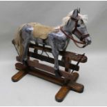 A late Victorian carved wood rocking mule, grey dapple painted, horsehair mane and tail, leather bri