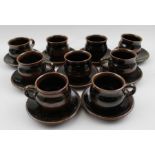 A set of nine Winchcombe pottery glazed stoneware coffee cups and saucers