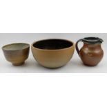 Three items of Winchcombe pottery including a 17.5 diameter bowl a smaller bowl and milk jug