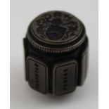 A cast metal multi-seal, to one end a heraldic crest, faceted to the sides the days of the week