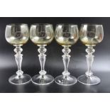 A set of four stemmed wine glasses, with green tinted bowls, and wrythen knop stems