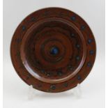 A glazed studio Winchcombe pottery charger, bears studio impressed mark, 27cm in diameter