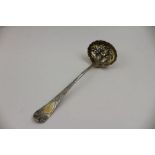 John Lias, a Georgian gilded silver sugar sifting ladle, embossed fruit to the bowl, London 1800, 53