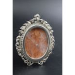 A Victorian silver miniature photograph frame, marcasite mounted oval wreath form with ribbon crest,