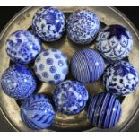 A collection of eleven blue & white pottery carpet bowls, different designs
