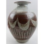 A studio pottery vase of ovoid form, with flared rim, glazed swag decoration, incised "James" to the