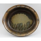 An oval Toft studio pottery stoneware bowl, with sheep design, 30cm x 25cm