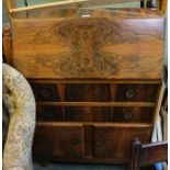 A fancy veneered bureau unit with flower head handles