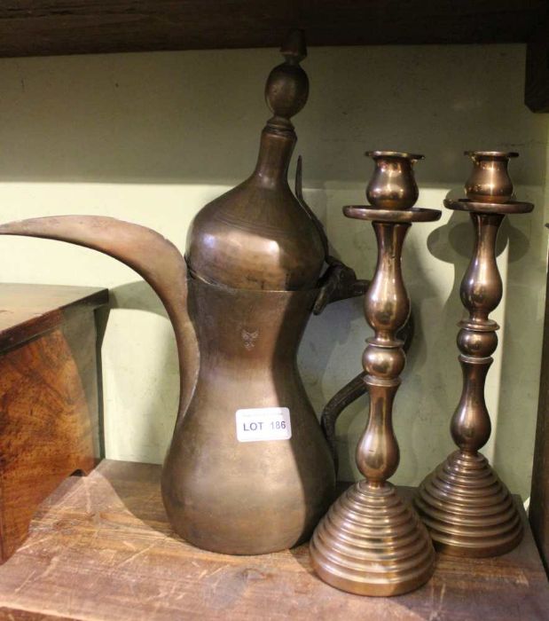 A pair of bell metal candlesticks, and an Eastern coffee pot