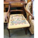 A Regency mahogany reeded armchair with needlework drop in seatpad over sabre legs