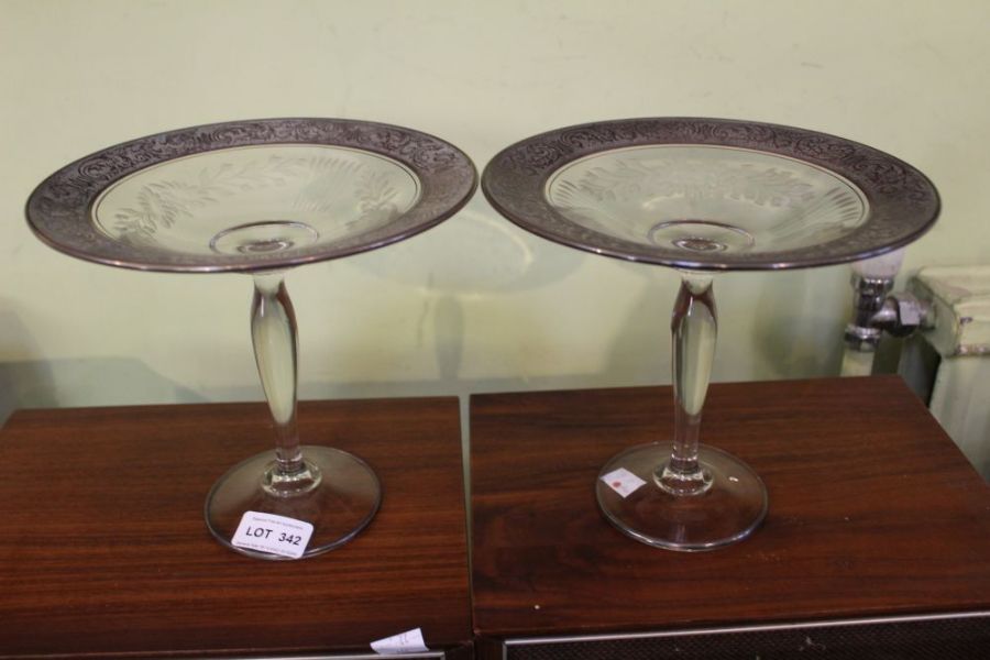 A pair of part etched tall glass comports, with plain stems and feet, 18cm high