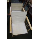 A pair of folding directors chairs, white canvas backs & seats