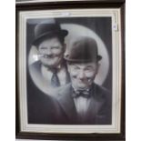 A large framed poster print of Laurel & Hardy with signature, S Coffield