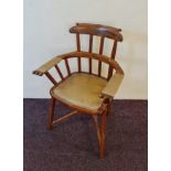 An oak arts and crafts arm chair.