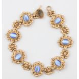 A hallmarked 9ct yellow gold blue stone cabochon bracelet, each stone surrounded by open metalwork