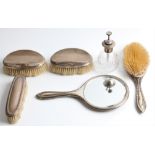 A hallmarked silver backed dressing table set, comprising a clothes brush, a hair brush and a