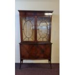 A mahogany two glazed door top display cabinet with two door cupboard base