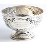 A Victorian silver rose bowl, featuring repousse scroll, foliage and floral design, with engraving