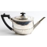 A George III silver tea pot with gadrooned lower body and spout, engraved with monogram, black