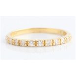 A cubic zirconia half eternity ring, stamped 750, ring size M. BOOK A VIEWING TIME SLOT ON OUR