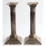 A pair of weighted column design candle sticks, unmarked white metal, approx. height 21cm. BOOK A