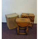 An oak sewing box together with a Lloyd Loom basket and a small oak reproduction table.