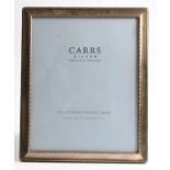 A silver photo frame, the rectangular design featuring repeat pattern to edge, hallmarked