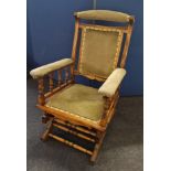 A Edwardian walnut American style rocking chair. IMPORTANT: Online viewing and bidding only.