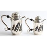 A Goldsmiths & Silversmiths Company silver coffee pot and tea pot, both of swirled design, with fish