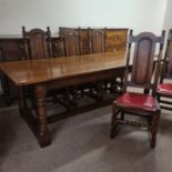 A Titchmarsh and Goodwin style solid oak refectory dining table together with eight matching panel
