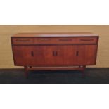 A G Plan teak sideboard with three drawers and four doors.