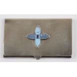 A silver and enamel card holder, featuring central quatrefoil blue enamelled motif with blue stone