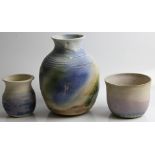A Molly Finlayson studio pottery vase, together with two pots, with blue and cream glazing.