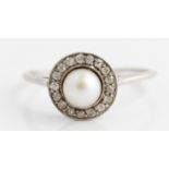 A diamond and pearl cluster halo ring, set with a central pearl, approx. 6mm, surrounded by a border