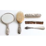 A hallmarked silver matched dressing table set, comprising of a hand mirror, a hair brush, a comb (