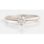 A hallmarked 18ct white gold diamond solitaire ring, set with a central round brilliant cut diamond,